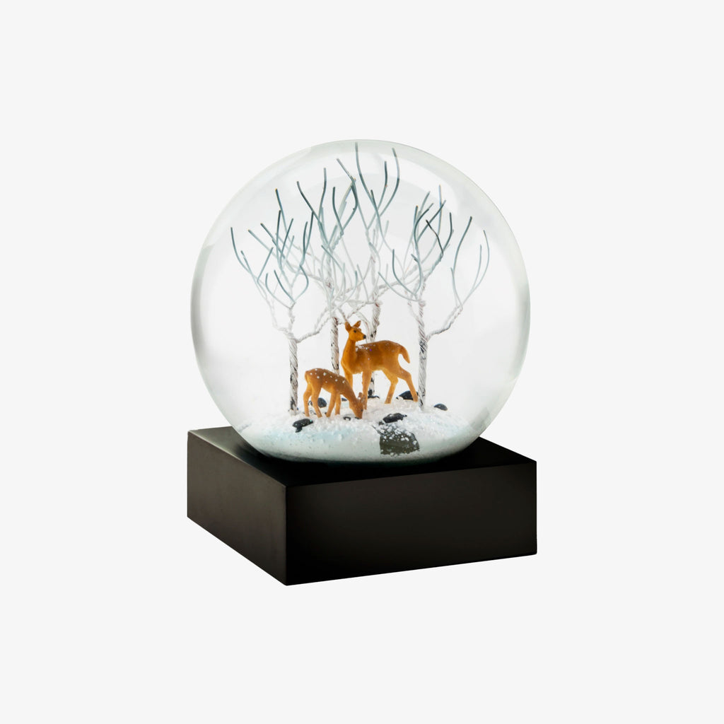 Snow globe with two deer and white trees on a white background