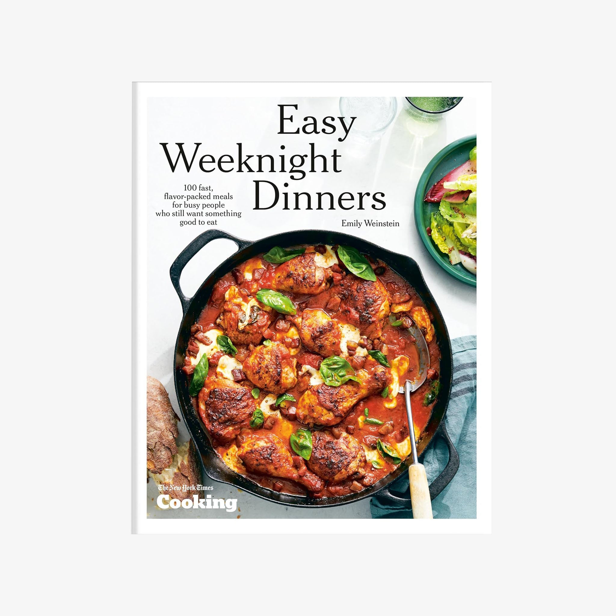 Front cover of cookbook Easy Weeknight Dinners Cookbook featuring chicken in a cast iron pan on a white background