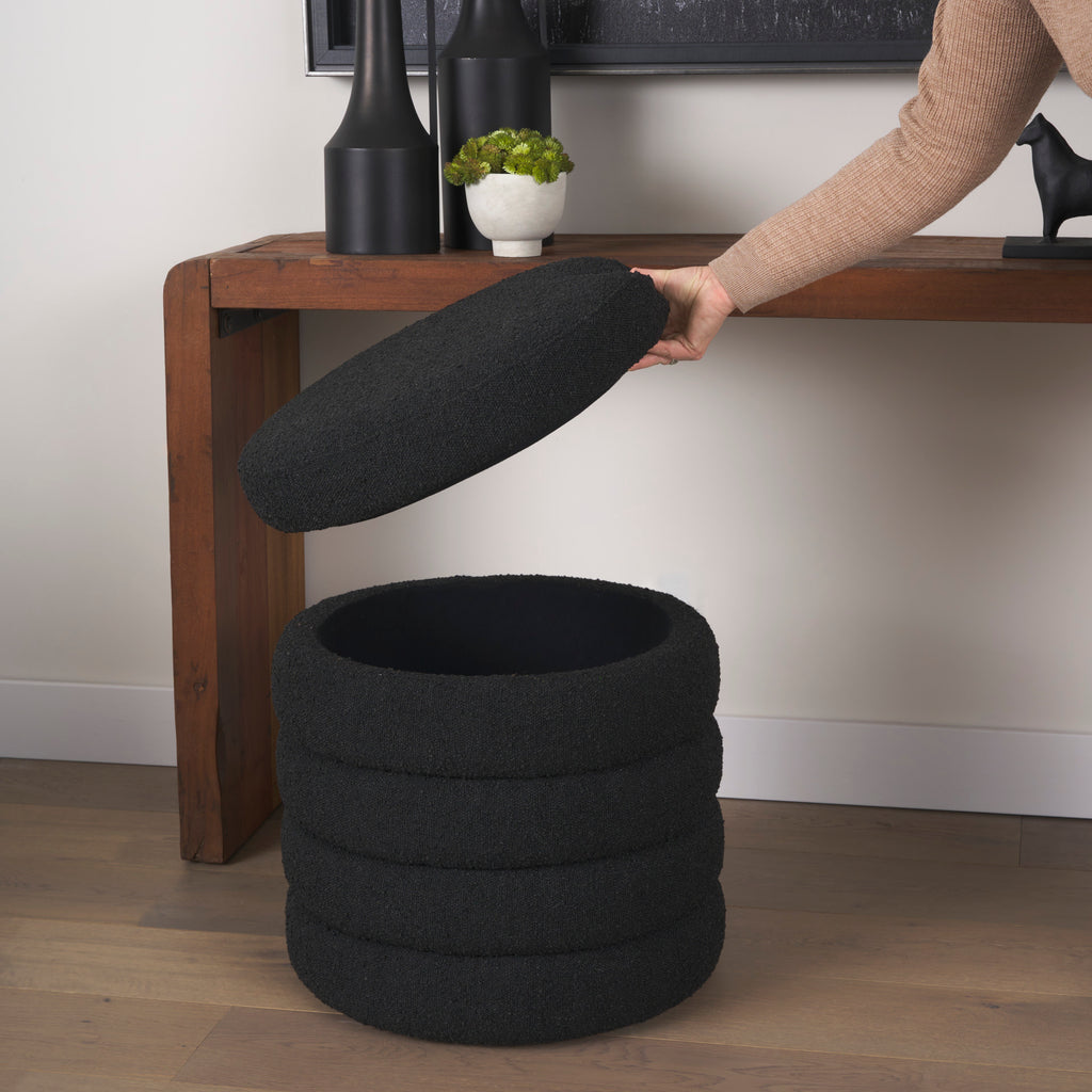 Elise Black Boucle Upholstered Storage Ottoman with someone lifting the storage lid