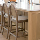Elle Rounded Caneback Medium Brown Wood with Oatmeal Fabric Counter at a kitchen counter bar area