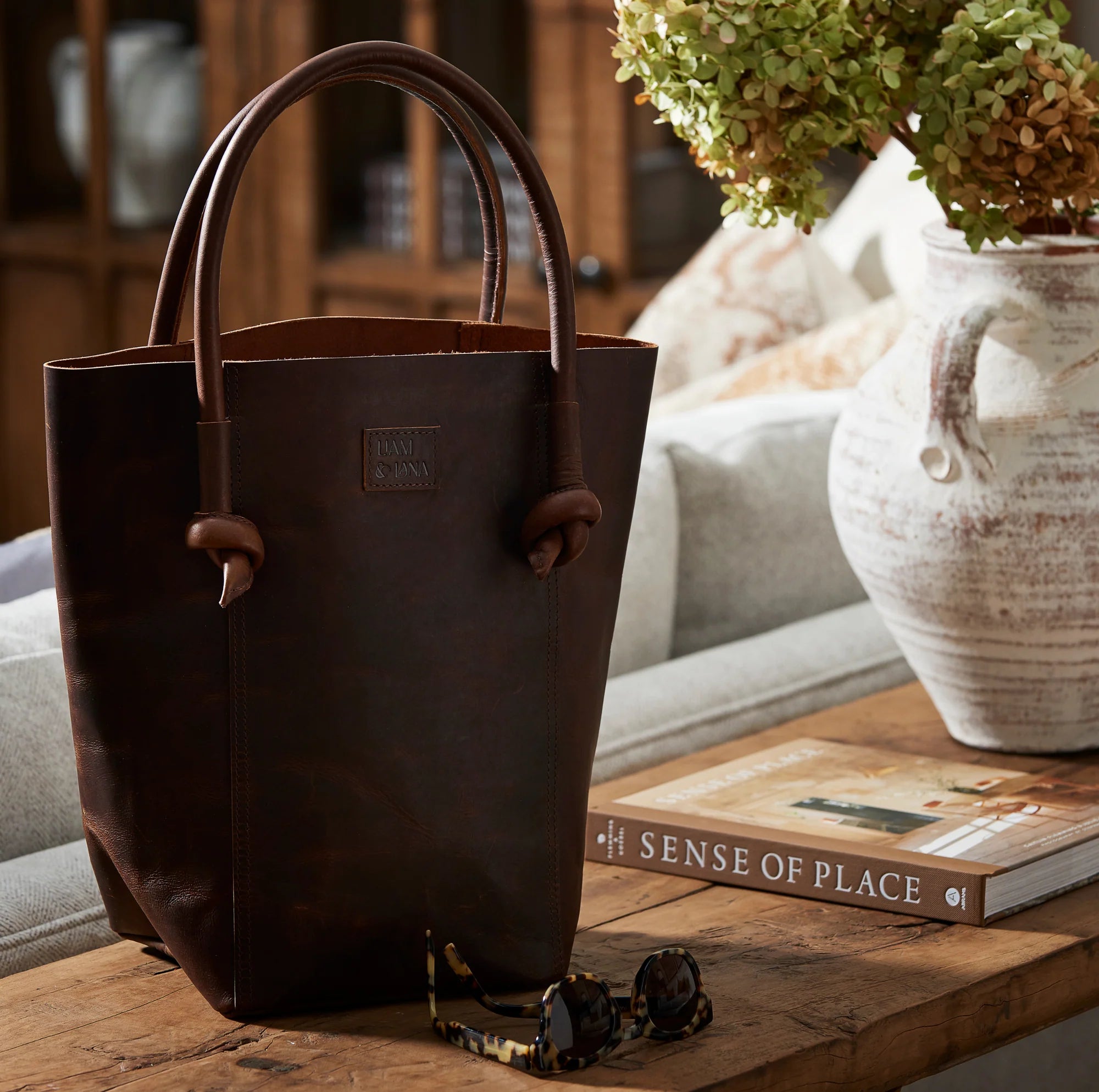 Elsie Leather Tote in Antique Brown on a table at Addison West
