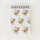 Notebook with floral design on a white background