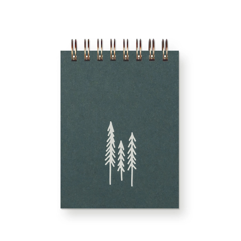 Small green spiral notepad with three white evergreen trees on the front