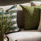 Ezra Earth Pillow on a sofa at Addison West