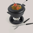Swissmar Lucerne Cast Iron Fondue Set in Matte Black on a white background at Addison West