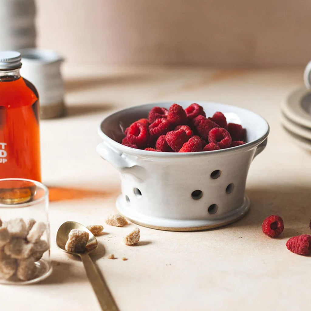 Farmhouse Pottery Countryman Berry Bowl with raspberries inside on a white wood counter