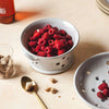 Farmhouse Pottery Countryman Berry Bowl with raspberries inside on a white wood counter