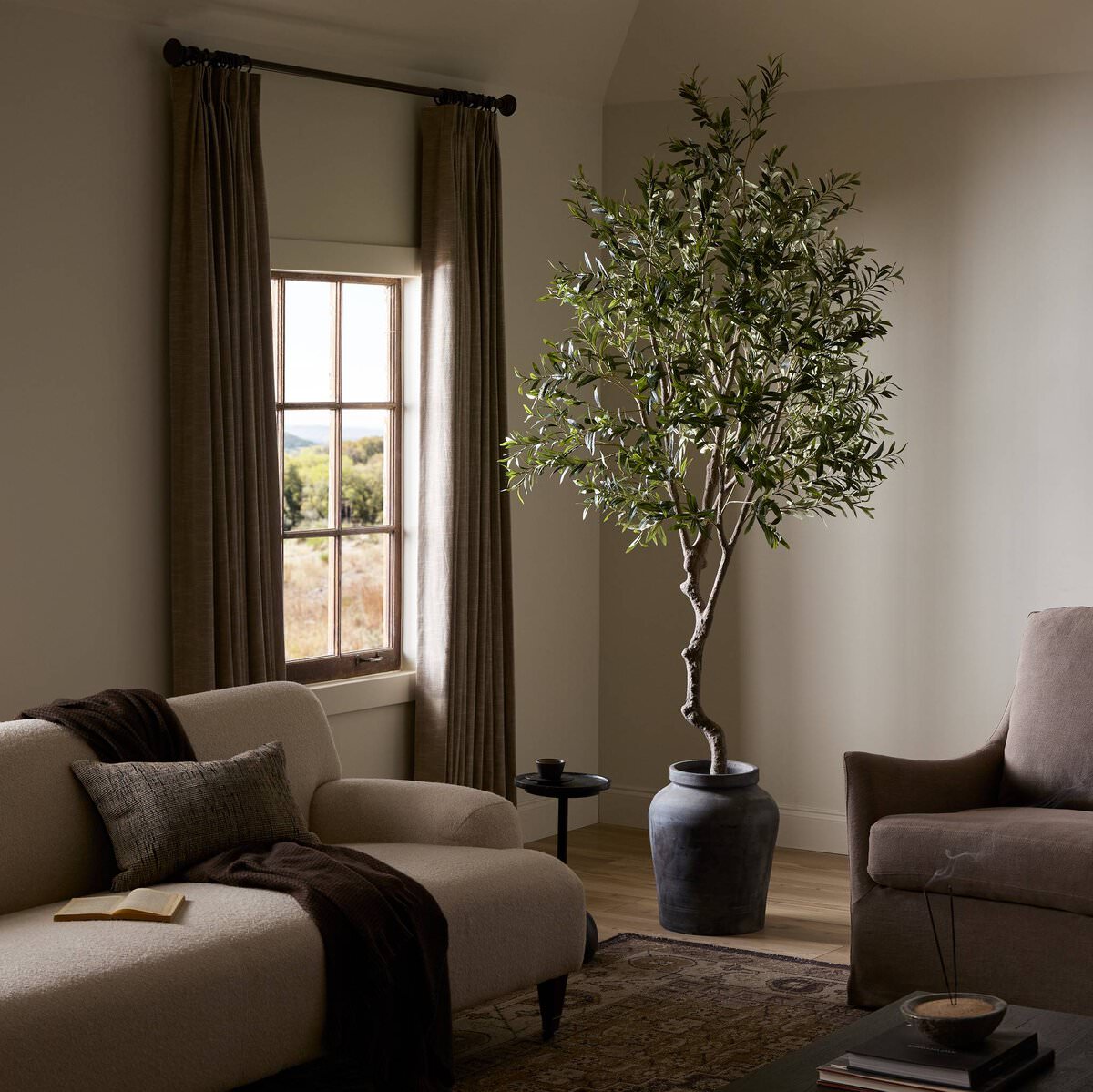 Faux Olive Tree in a living room at Addison West