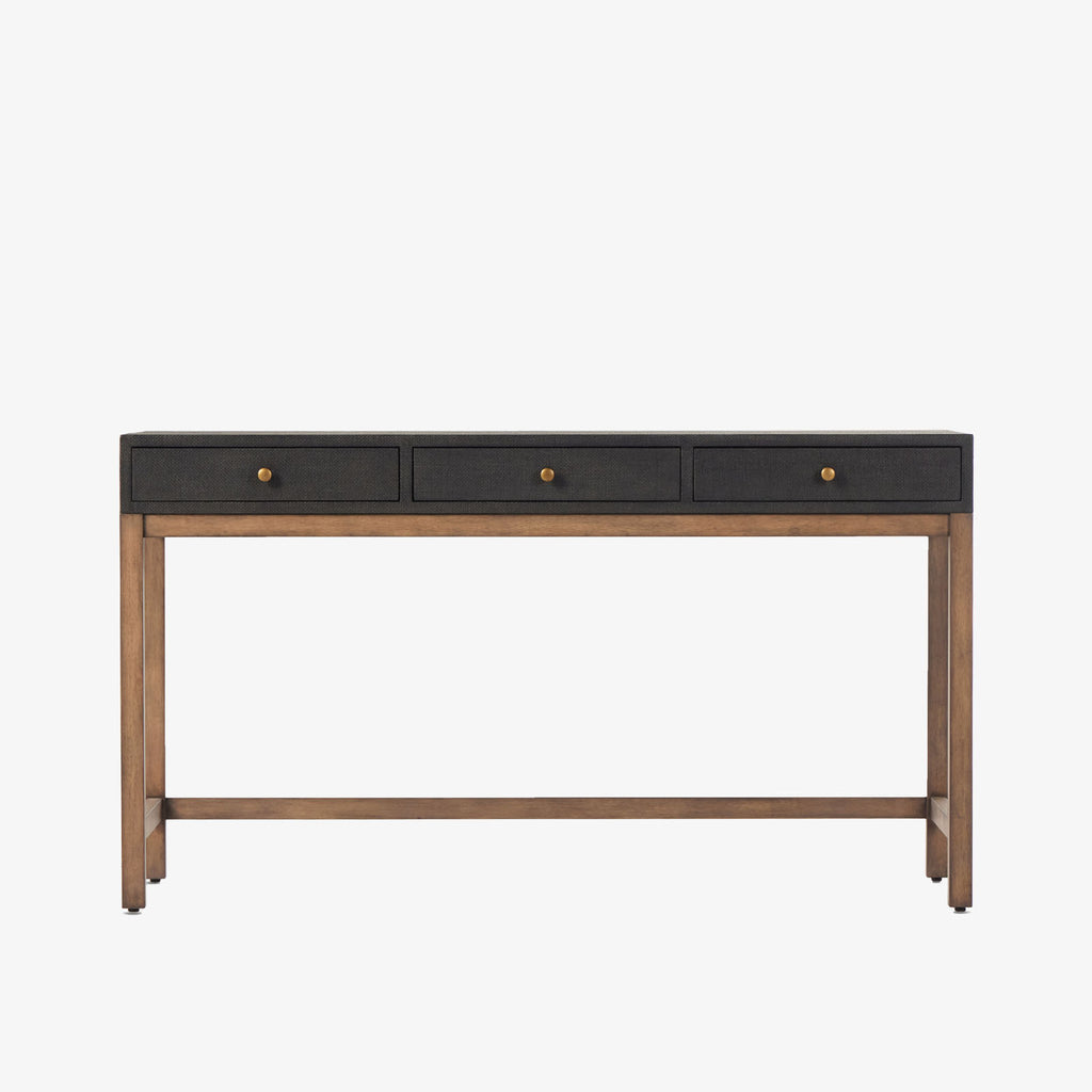 Four Hands Fiona Desk in Black Raffia with brass legs on a white background