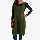 Person wearing a green apron on a white background