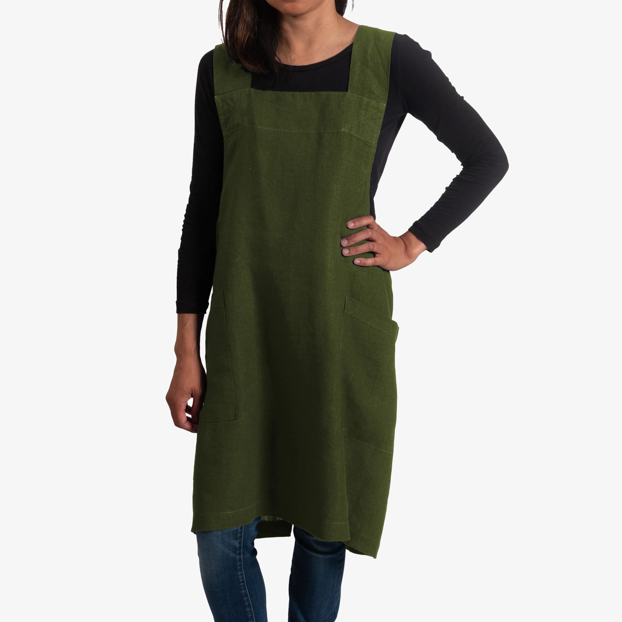 Person wearing a green apron on a white background