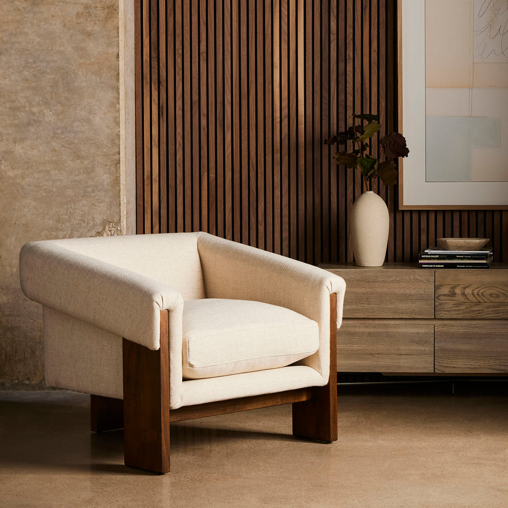 Four hands brand Cairo chair in thames cream in a wood paneled room
