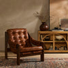 Four Hands Halston Chair In Heirloom Sienna in a living room with warm brown walls and a tribal rug
