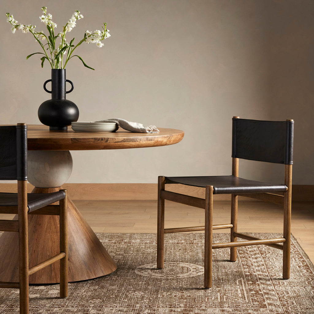 Four Hands Kena Dining Chair in Sonoma Black in a moody dining room