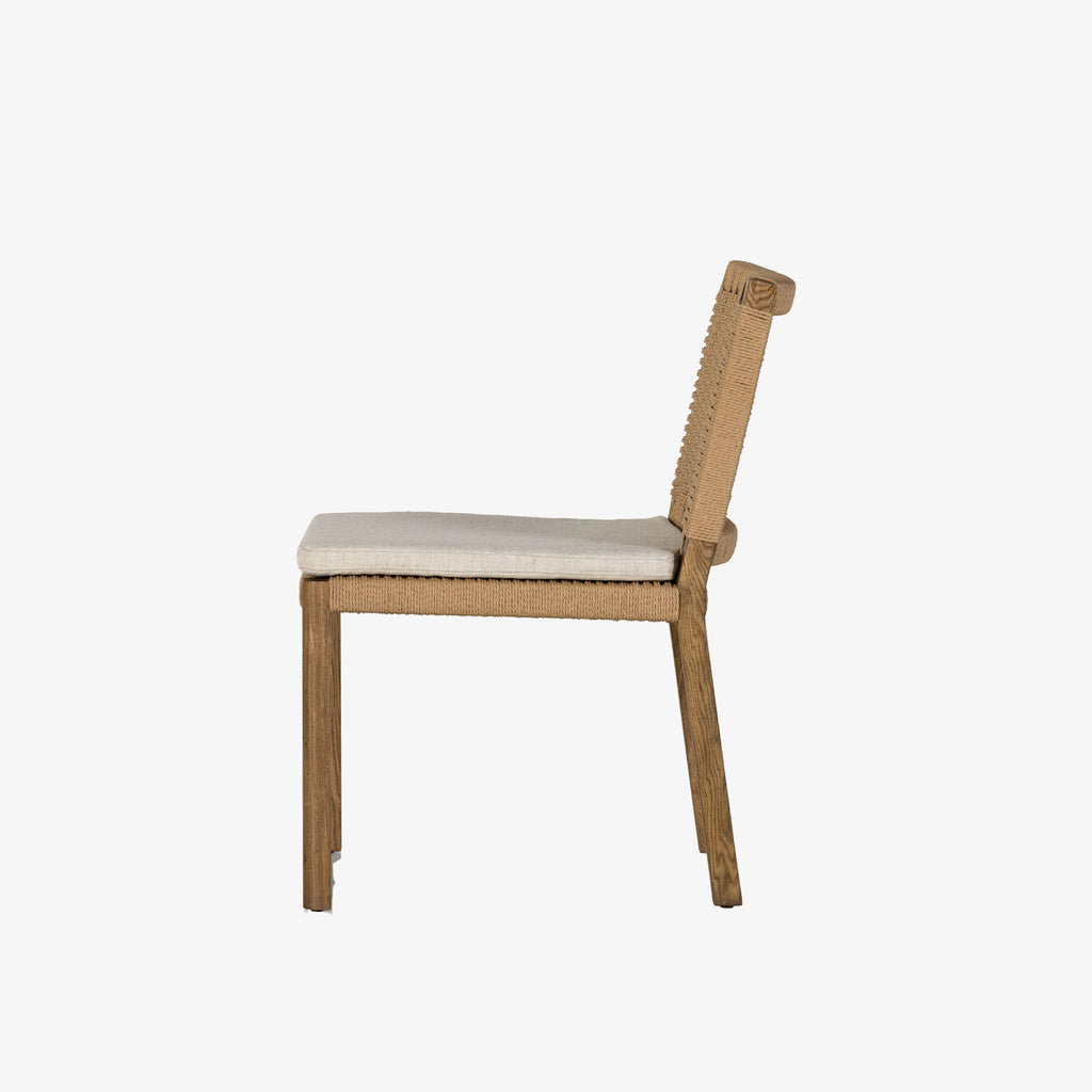 Four Hands Zuma Dining Chair with beige cushion and woven back in Dune Ash on a white background