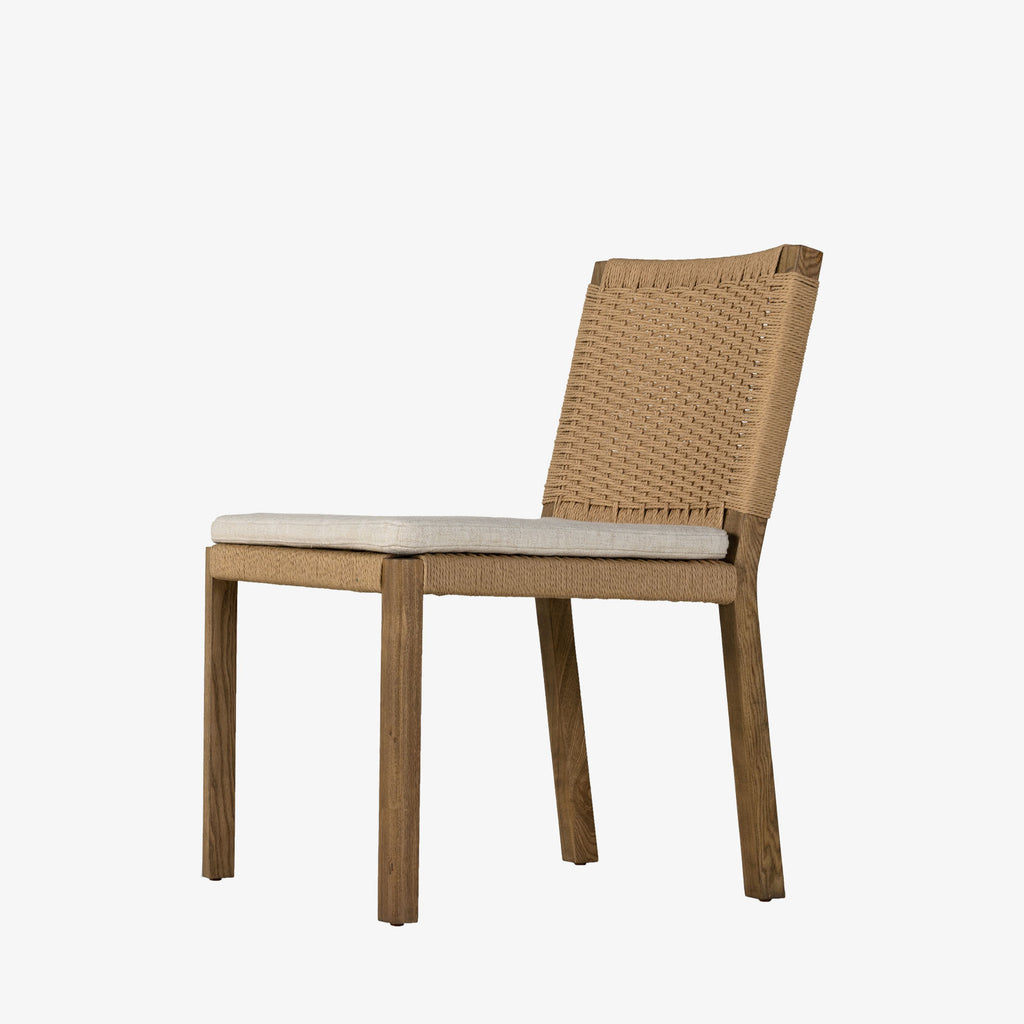 Four Hands Zuma Dining Chair with beige cushion and woven back in Dune Ash on a white background
