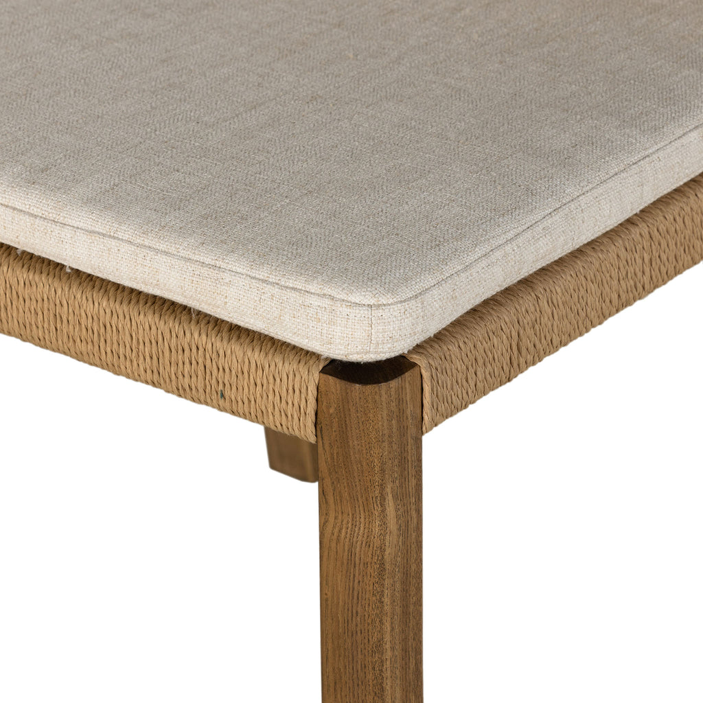 Four Hands Zuma Dining Chair with beige cushion and woven back in Dune Ash on a white background
