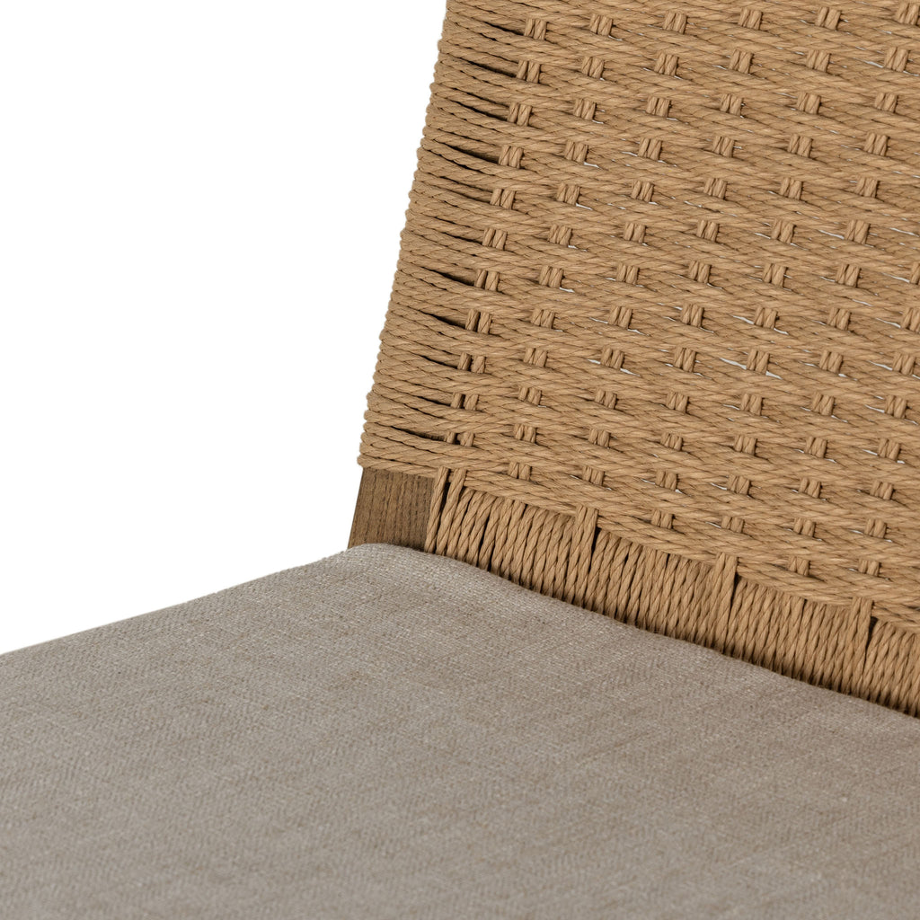 Four Hands Zuma Dining Chair with beige cushion and woven back in Dune Ash on a white background