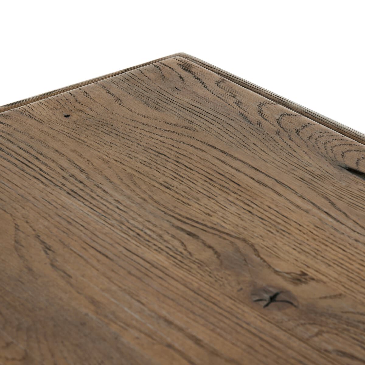 Close up of Four Hands 85.5" Glenview Dining Table in Weathered Oak Veneer on a white background at Addison West