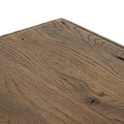 Close up of Four Hands 85.5" Glenview Dining Table in Weathered Oak Veneer on a white background at Addison West