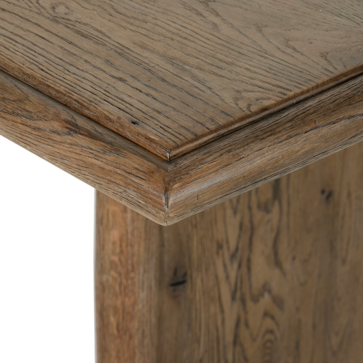 Close up of Four Hands 85.5" Glenview Dining Table in Weathered Oak Veneer on a white background at Addison West