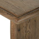 Close up of Four Hands 85.5" Glenview Dining Table in Weathered Oak Veneer on a white background at Addison West