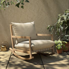 Four Hands Aiken Outdoor Rocking Chair in Faye Sand on a patio at Addison West