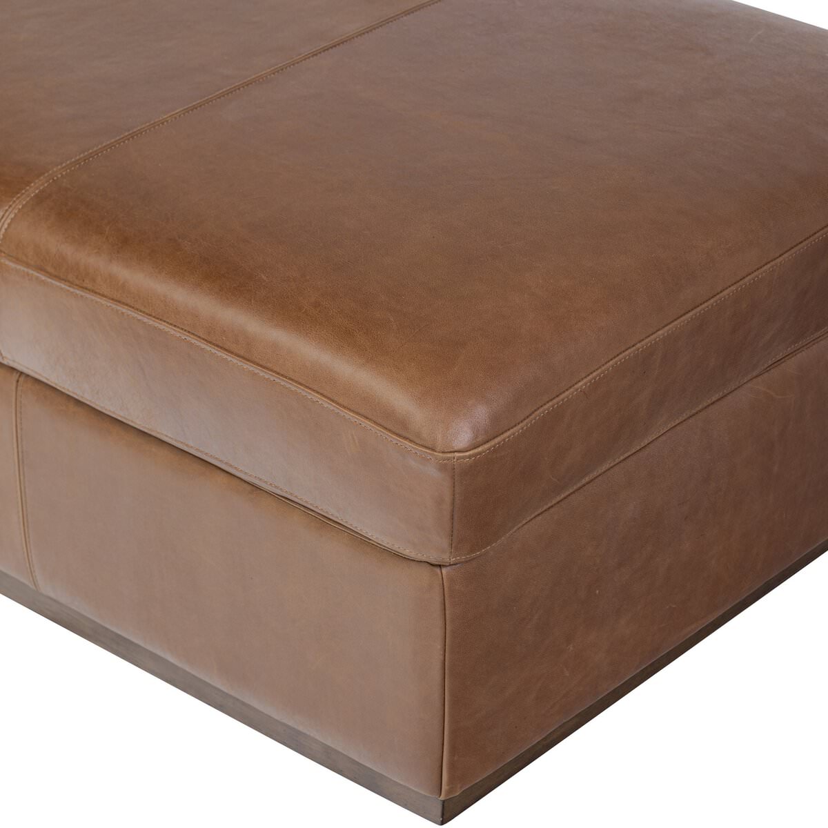 Close up of Four Hands Alec Storage Ottoman in Dulane Mahogany on a white background at Addison West