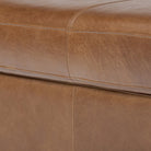 Close up of Four Hands Alec Storage Ottoman in Dulane Mahogany on a white background at Addison West