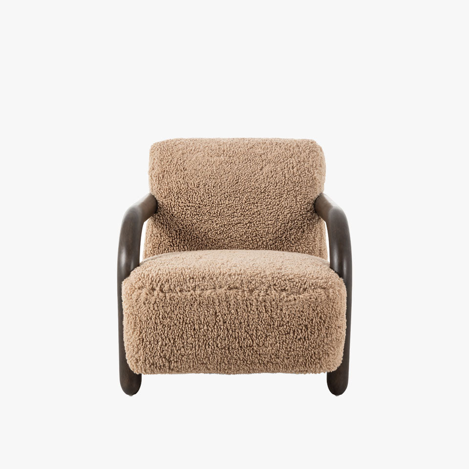 Four Hands Aniston Chair In Andes Toast with sheepskin like upholstery and wood frame on a white background