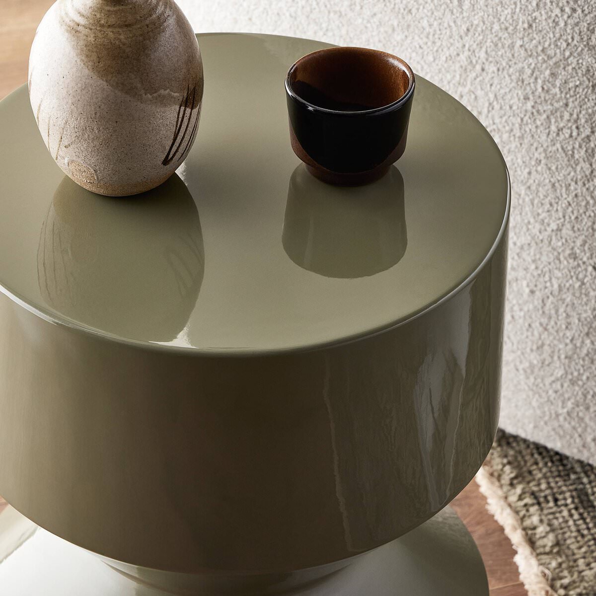 Close up of Four Hands Ara End Table in Moss Lacquered Concrete in a living room
