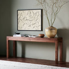 Four Hands Arturo Console Table in Natural Walnut Veneer in a modern home with green walls