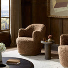 Four Hands Aurora Swivel Chair in Amber Shearling in a living room at Addison West