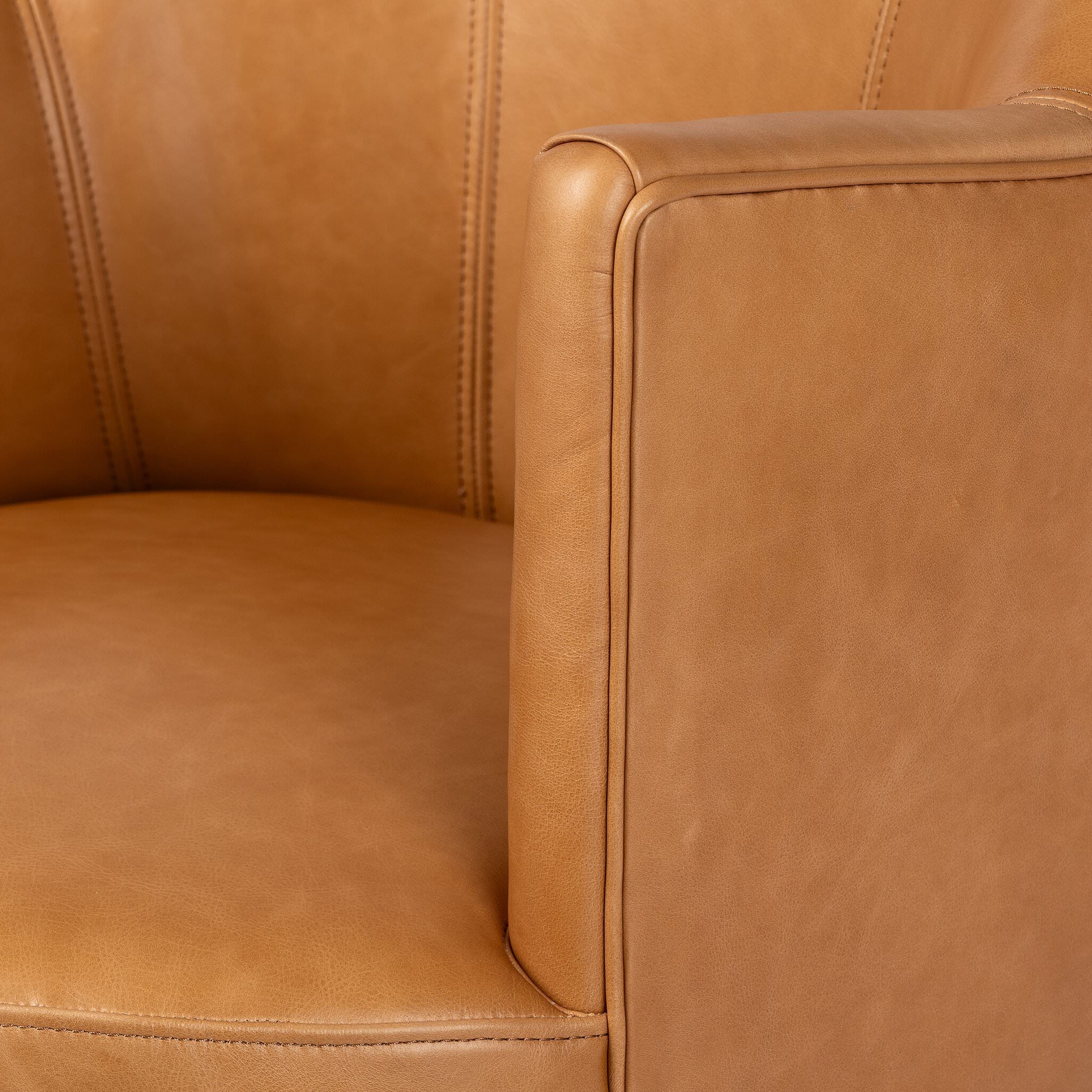 Close up of Four Hands Aurora Swivel Chair in Sonoma Butterscotch on a white background at Addison West
