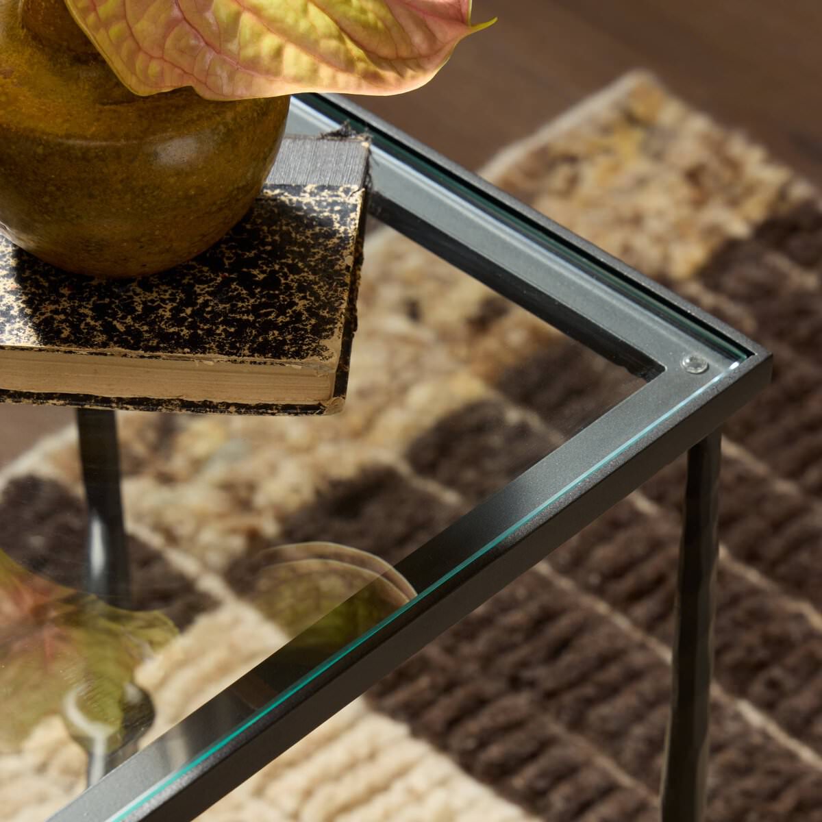 Close up of Four Hands Babylon Small End Table in Hammered Gunmetal in a living room at Addison West