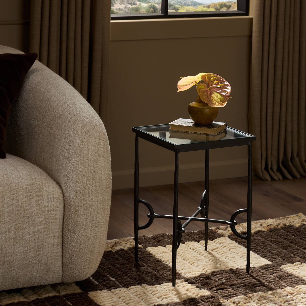 Four Hands Babylon Small End Table in Hammered Gunmetal in a living room at Addison West