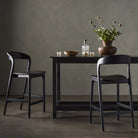 Four Hands Bar Stool in Sonoma Black in a grey dining room at Addison West