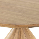 Close up of Four Hands Bibianna Round 60" Dining Table in Blush Marble on a white background