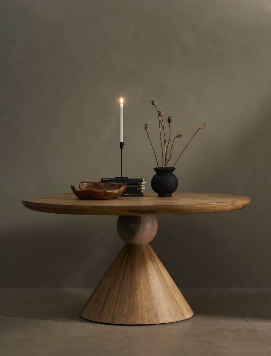 Four Hands Bibianna Round 60" Dining Table in Blush Marble against a beige background