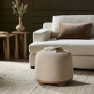 Four Hands Bilbury Ottoman in Saxon Sand in a living room with green walls at Addison West