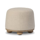 Four Hands Bilbury Ottoman in Saxon Sand on a white background at Addison West