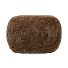 Four Hands Bilbury Oval Ottoman in Amber Shearling on white background at Addison West.