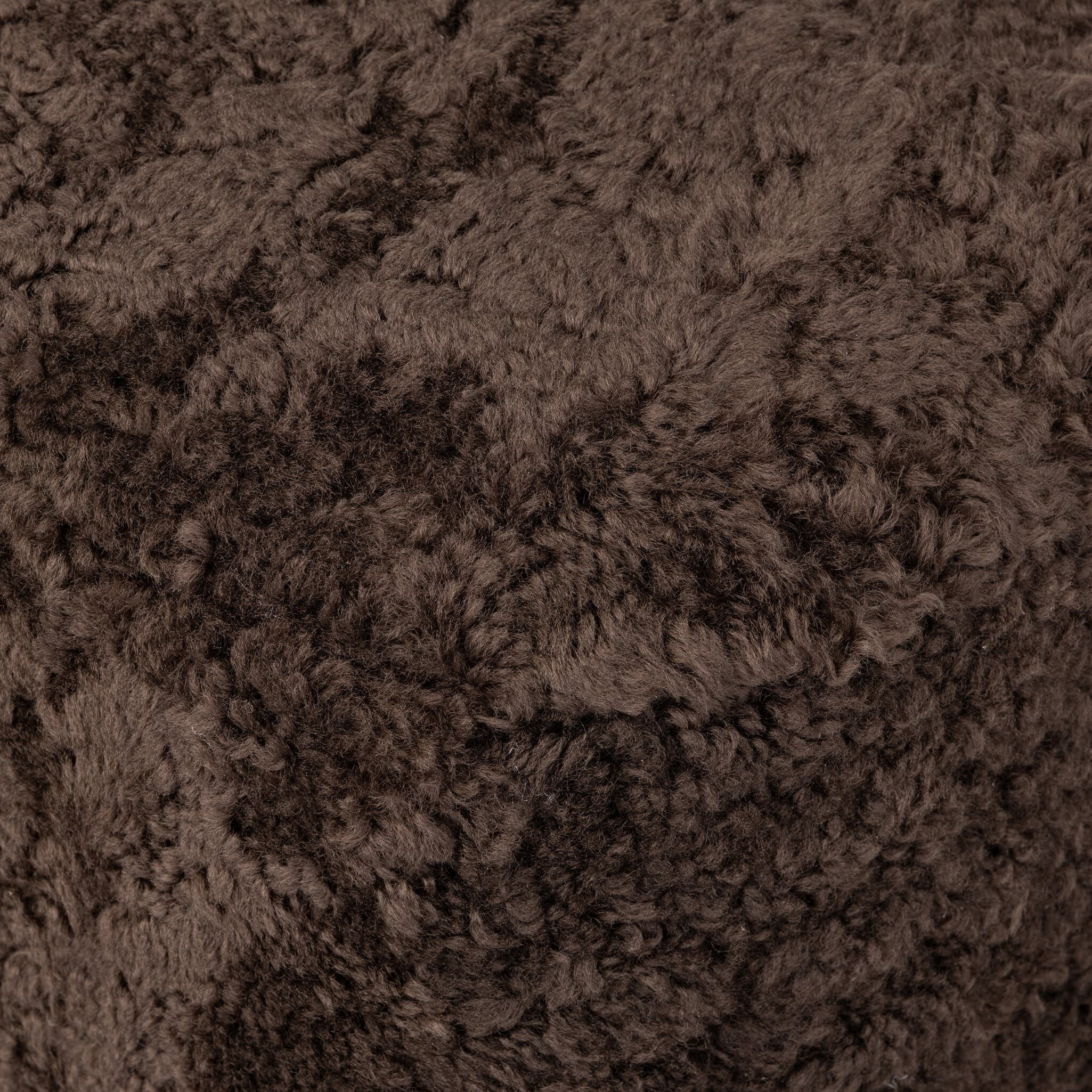 Four Hands Bilbury Oval Ottoman in Cocoa Shearling on white background at Addison West.