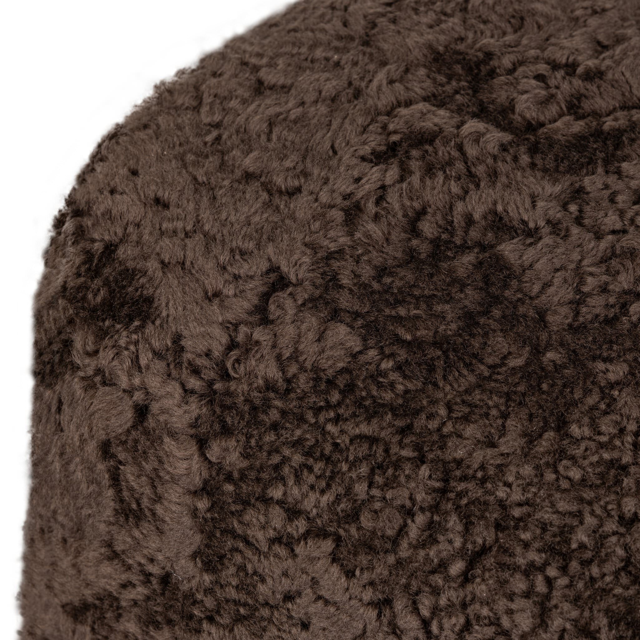 Four Hands Bilbury Oval Ottoman in Cocoa Shearling on white background at Addison West.