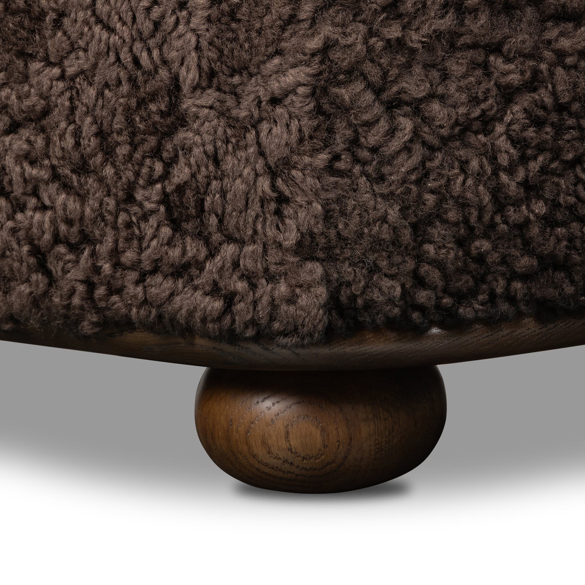 Four Hands Bilbury Oval Ottoman in Cocoa Shearling on white background at Addison West.