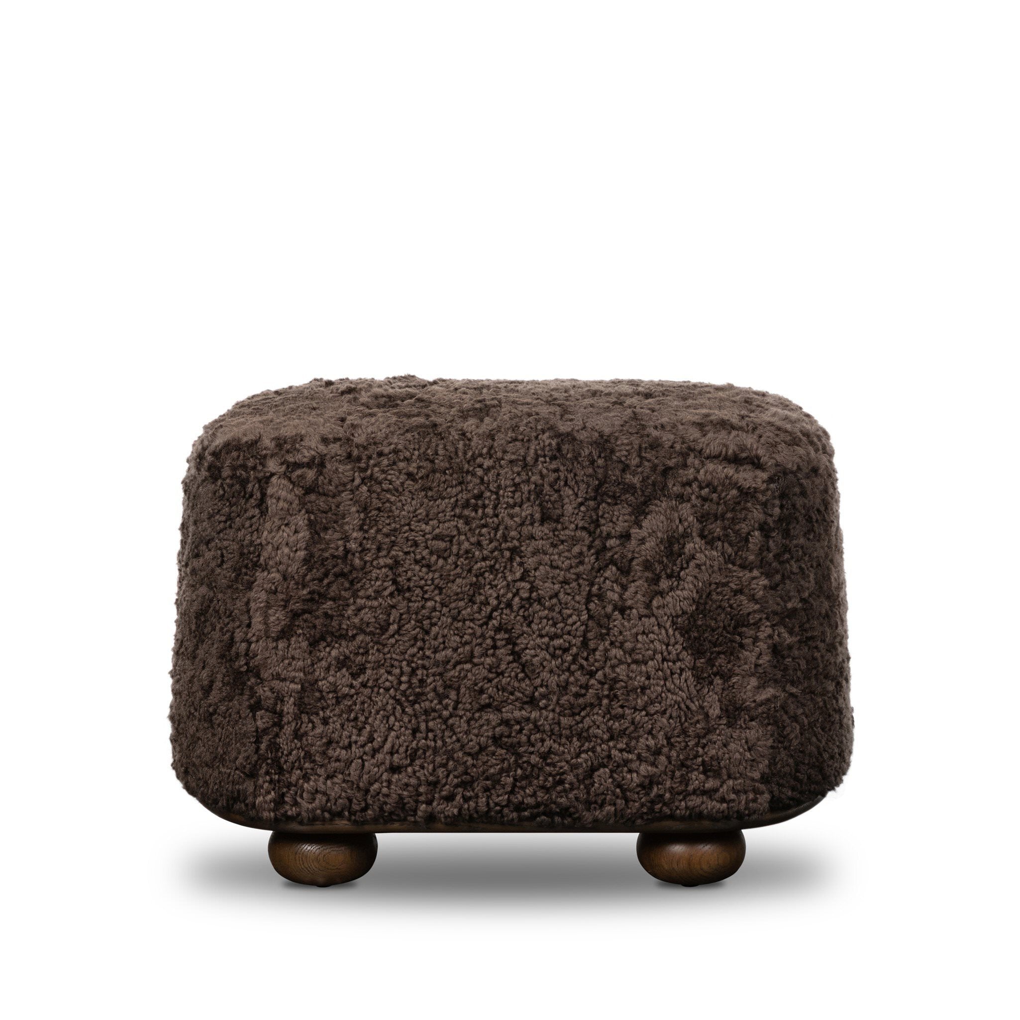 Four Hands Bilbury Oval Ottoman in Cocoa Shearling on white background at Addison West.