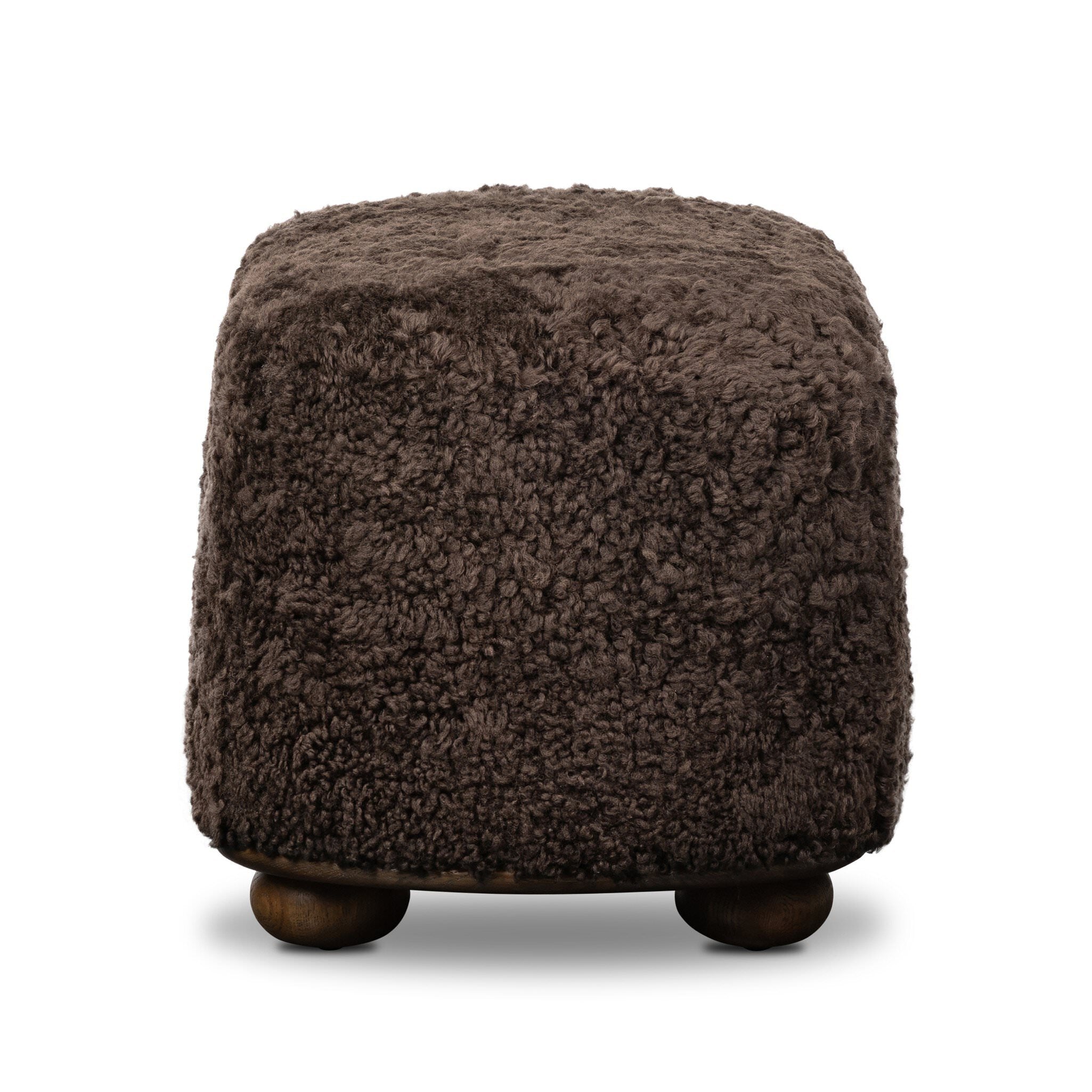 Four Hands Bilbury Oval Ottoman in Cocoa Shearling on white background at Addison West.
