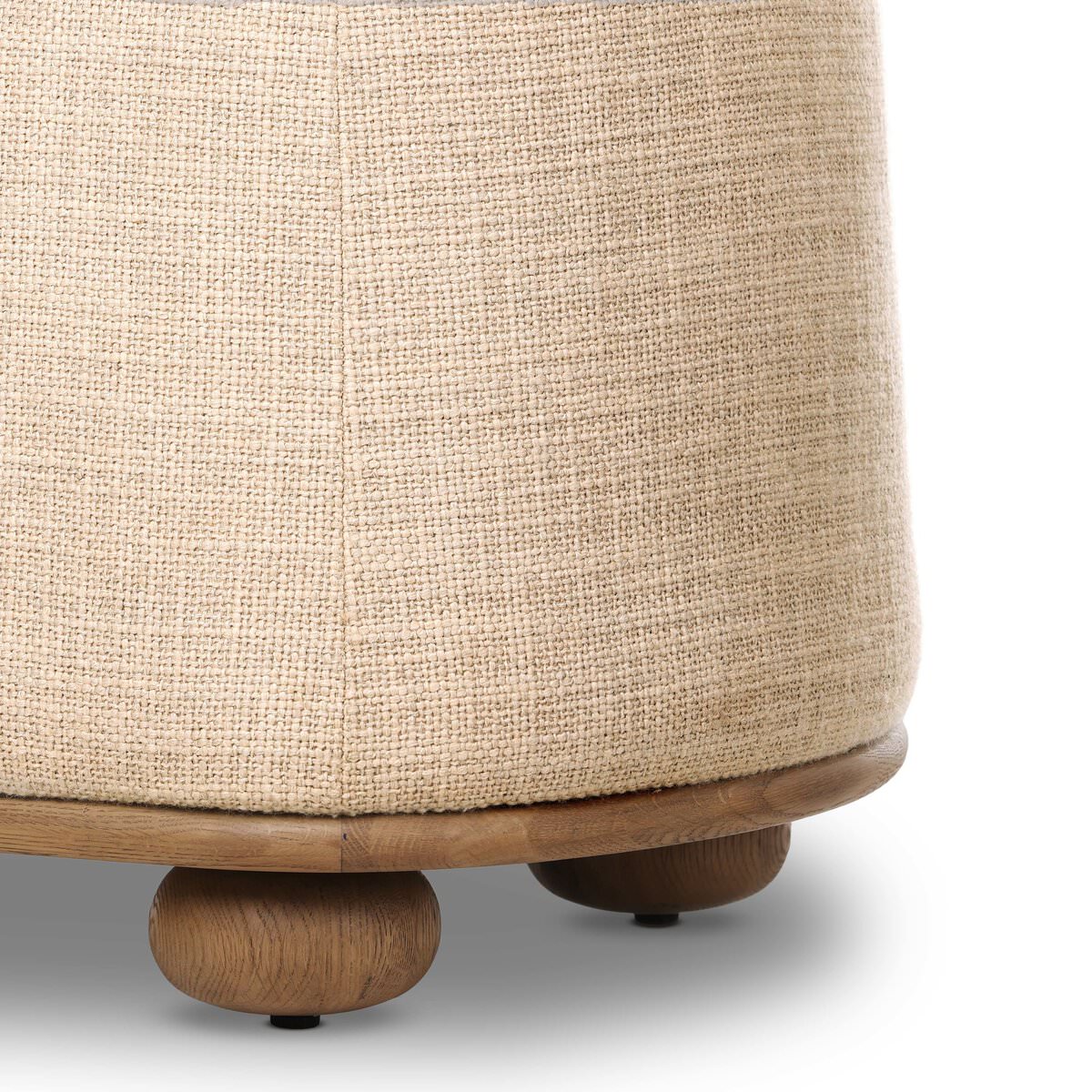 Close up of Four Hands Bilbury Oval Ottoman in Saxon Sand on a white background at Addison West