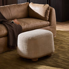 Four Hands Bilbury Oval Ottoman in Saxon Sand in a living room at Addison West