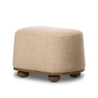 Four Hands Bilbury Oval Ottoman in Saxon Sand on a white background at Addison West